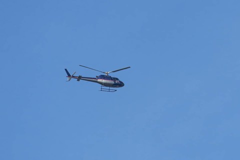 Airbus H125 helicopter flying in a blue sky, England, United Kingdom