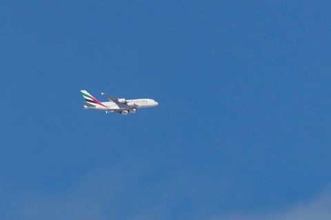 Airbus A380 jet passenger aircraft of Emirates airlines flying in a blue sky, England, United