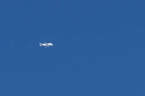 Airbus A330-743L Beluga XL cargo jet aircraft flying in a blue sky with white clouds, England,