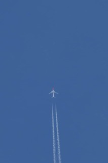 Boeing 737 jet passenger aircraft of Norwegian Air airlines flying in a blue sky with contrails or