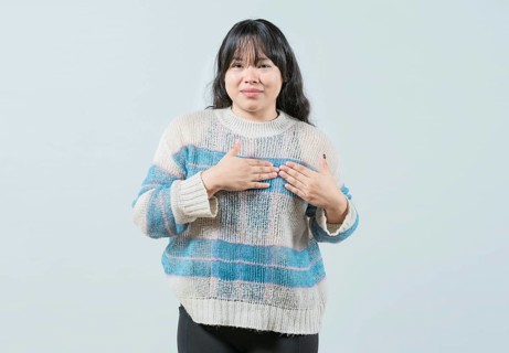 Asian girl gesturing GRATITUDE in sign language. Young woman making gesture GRATEFUL in sign