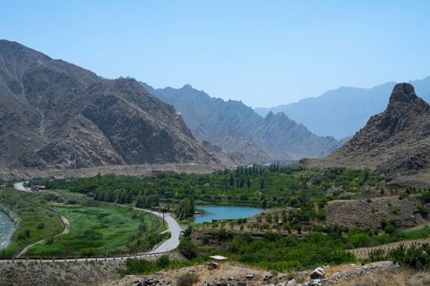 A picturesque valley with a river, surrounded by high mountains and lots of greenery, view of Iran,