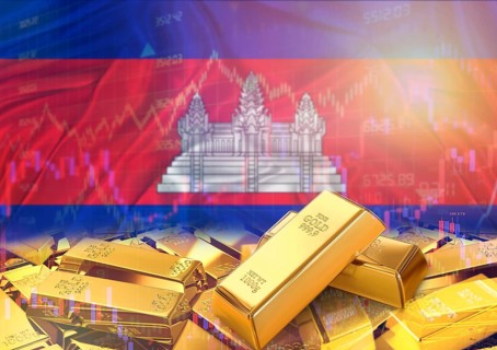 Gold bars on Cambodia flag in background. Gold bars stacked on Cambodian flag. Concept of Cambodia