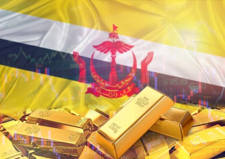 Gold bars on Brunei flag in background. Gold bars stacked on Bruneian flag. Concept of Brunei gold
