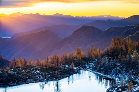Laghetto dei Saléi mountain lake with autumnal larches (Larix) at sunrise, Onsernone Valley, Canton
