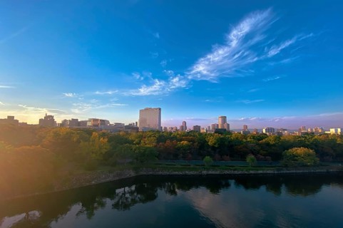 Japan, panoramic view of Osaka skyline from Osaka castle at sunset