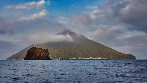Stromboli island with offshore islet Strombolicchio, volcanic island with picturesque village