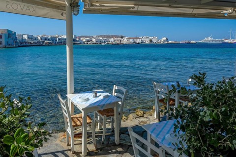 Mykonos, Cyclades, Greece - Small picturesque tavern right on the waterfront, on the harbor in the