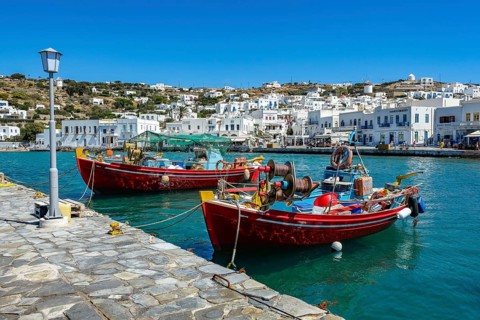 Mykonos, Cyclades, Greece - Colourful fishing boats are moored on the quay in the old port of