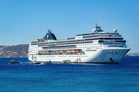 Mykonos, Cyclades, Greece - Cruise ship MSC Lirica is located in Mykonos Harbour Bay. Cruise ships