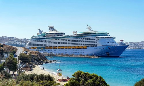 Mykonos, Cyclades, Greece - Voyager of the Seas cruise ship is located in Mykonos Harbour Bay. In