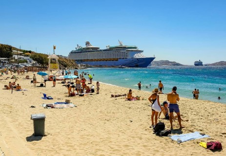 Mykonos, Cyclades, Greece - Voyager of the Seas cruise ship is located in Mykonos Harbour Bay. In