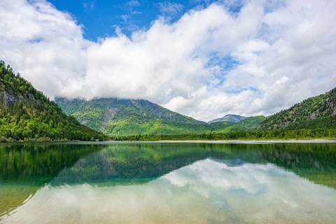 Landscape of Lake Offensee after rain when the sun comes through the clouds in spring,