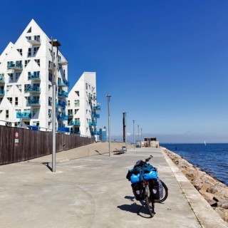 E-bike with luggage bags, bike tour, pyramid-shaped buildings, sunny summer weather, Isbjerget