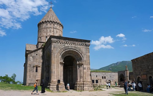Historic monastery with medieval architecture and impressive tower in scenic surroundings under