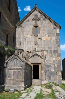 Historic church entrance with stone decorations and crosses, Tatev monastery, Tatev, Armenian