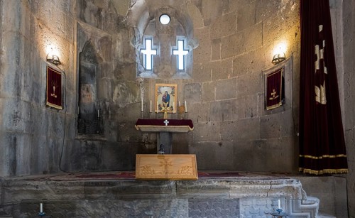 Choir with cross windows and candlelight, spiritual atmosphere, Tatev monastery, Armenian Apostolic