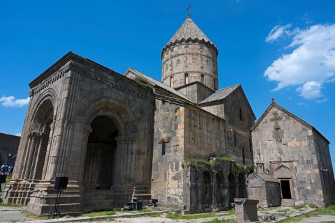 Historic stone church under blue sky, impressive architecture, Surb Pogos-Petros main church, Tatev
