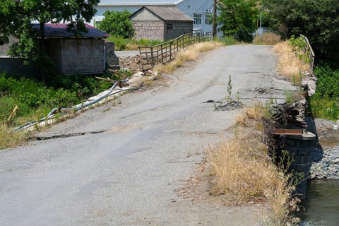 An old, damaged bridge crosses a small river in a rural area, bridge over the Debed River, Ayrum,