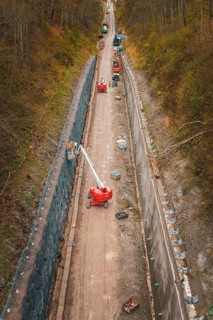 Construction work on a path in a wooded area with machines and a lift, construction of the Hermann