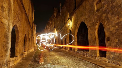 Knight's Town, night view of an old town alley with light paintings and historic buildings, UNESCO