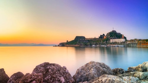 Old fortress, romantic view of a fortress at sunrise over calm water, UNESCO World Heritage Site,
