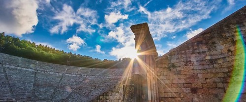 Rays of sun over ancient ruins, with a dramatic sky full of clouds, UNESCO World Heritage Site,