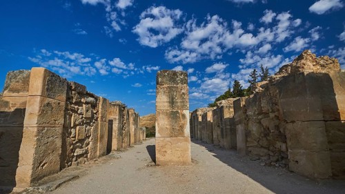 Old ruins with high stone walls under blue sky with scattered clouds, UNESCO World Heritage Site,