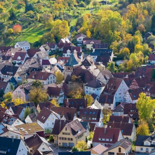 View of a picturesque village with red roofs and autumn trees, Strümpfelbach im Remstal,