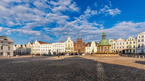 Wismar water art and restaurants on the market square in the old town, Hanseatic City of Wismar,