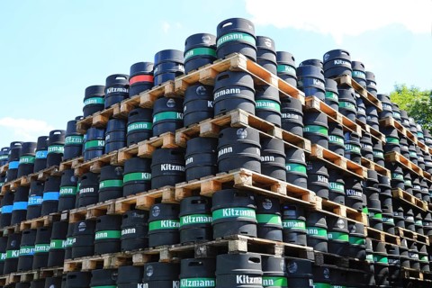 Black stacked beer kegs from the Kitzmann brewery, founded in Erlangen in 1712. Following the