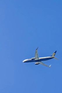 Ryanair passenger plane flying on a clear blue sky, Mallorca, Spain