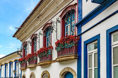 Facade of an old colonial-style houses with flowered balconies in the city of Ouro Preto, Minas