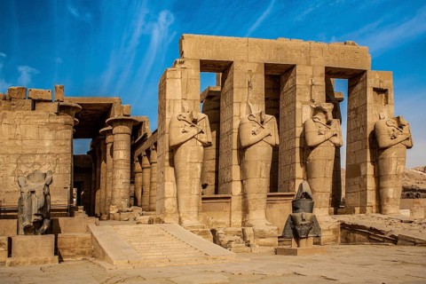 2nd courtyard with Osiris statues, head of a statue of Ramesses II in front of it, Ramesses II