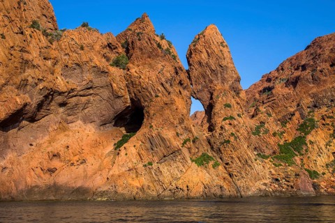 Rock formations and deep blue water in Scandola Nature Reserve, Corsica