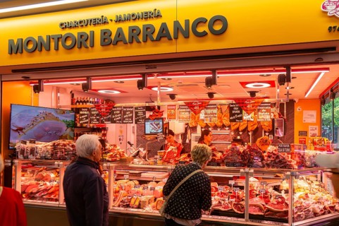Market stall shop store selling butcher meat products inside Mercado Central de Zaragoza, Zaragoza,