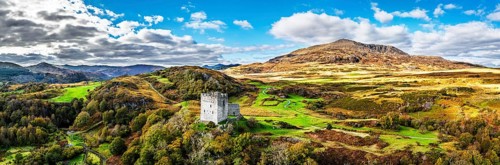 Autumn colours over Castell Dolwyddelan and Eryri Mountains from a drone, Snowdonia, Conwy County