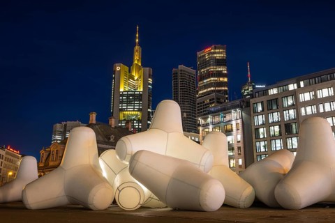 Illuminated tetrapods lie at Hauptwache in front of Frankfurt's banking skyline, Frankfurt, Hesse,