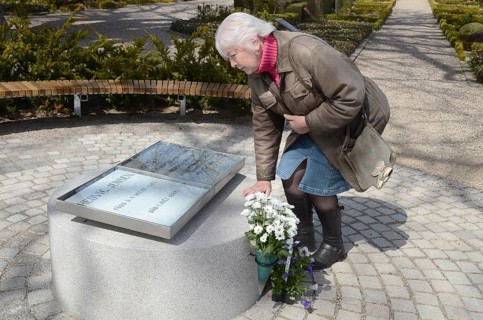 A woman looks at The grave of the love couple Danish circus artist Elvira Madigan Hedvig Jensen and