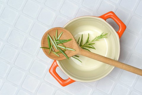 Rosemary, rosemary leaves on cooking spoon with cooking pot