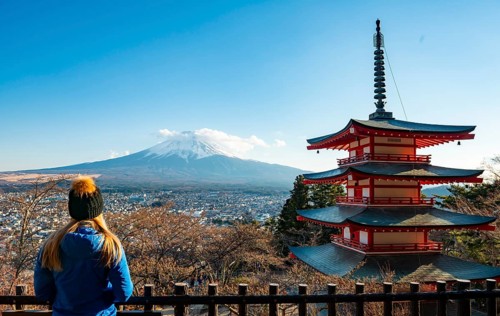 Tourist enjoying the view, five-story pagoda of a Shinto shrine, Chureito Pagoda, with views of