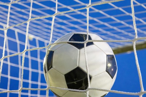 Soccer symbol: close-up of a soccer ball under floodlights