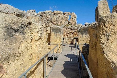 View from secured walkway with railing through ruins remains of Ggantija temple, UNESCO World