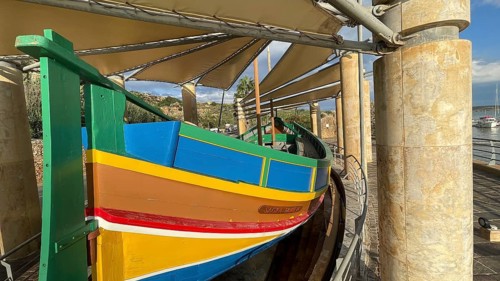 Monument to traditional fishing boats abandoned jacked up typical colorful painted old fishing boat
