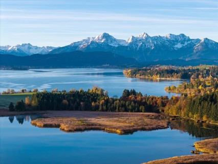 View of a lake with mountains in the background and autumn vegetation, Illasbergsee, Forggensee,
