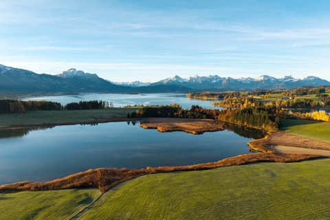 Landscape with a quiet lake surrounded by mountains and autumn vegetation, Illasbergsee,