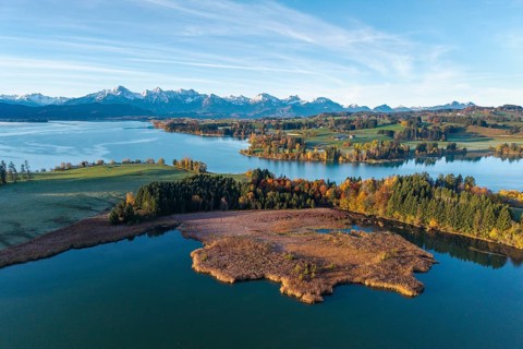 Extensive autumn landscape with a lake and a view of the mountains in the background, Illasbergsee,