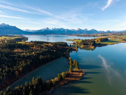 A quiet lake with forest and mountains, autumn colors are reflected in the water, Illasbergsee,