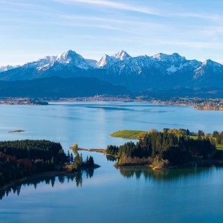 Quiet water area with forest islands and mountain range in the background, Illasbergsee,