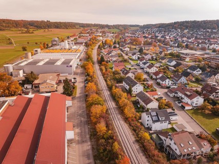 An autumnal panorama with a Hermann Hesse Railway railway line red roofs and residential buildings